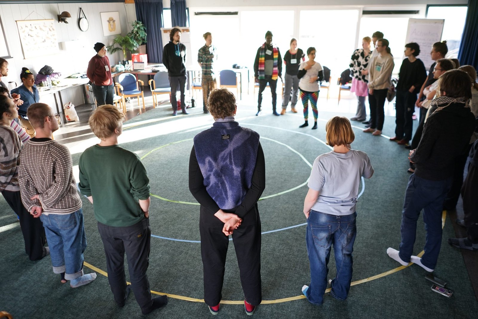 Participants standing in a circle at a workshop